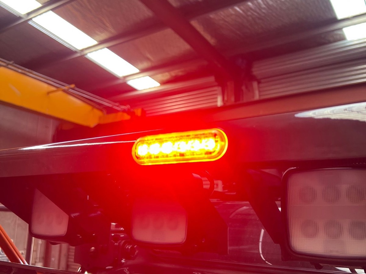 Amber LED strobe and work lights installed on a forklift overhead guard