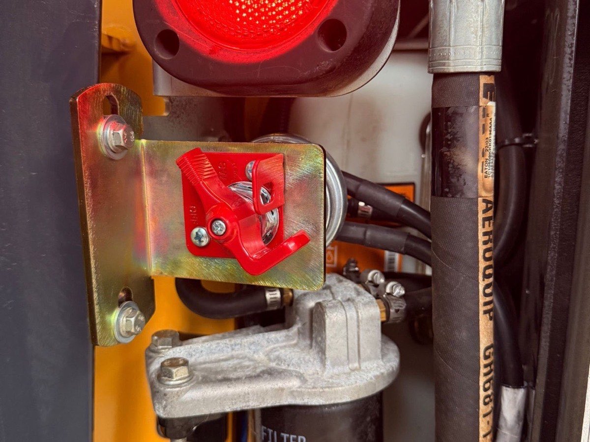 Red safety light and battery isolator switch installed on heavy machinery