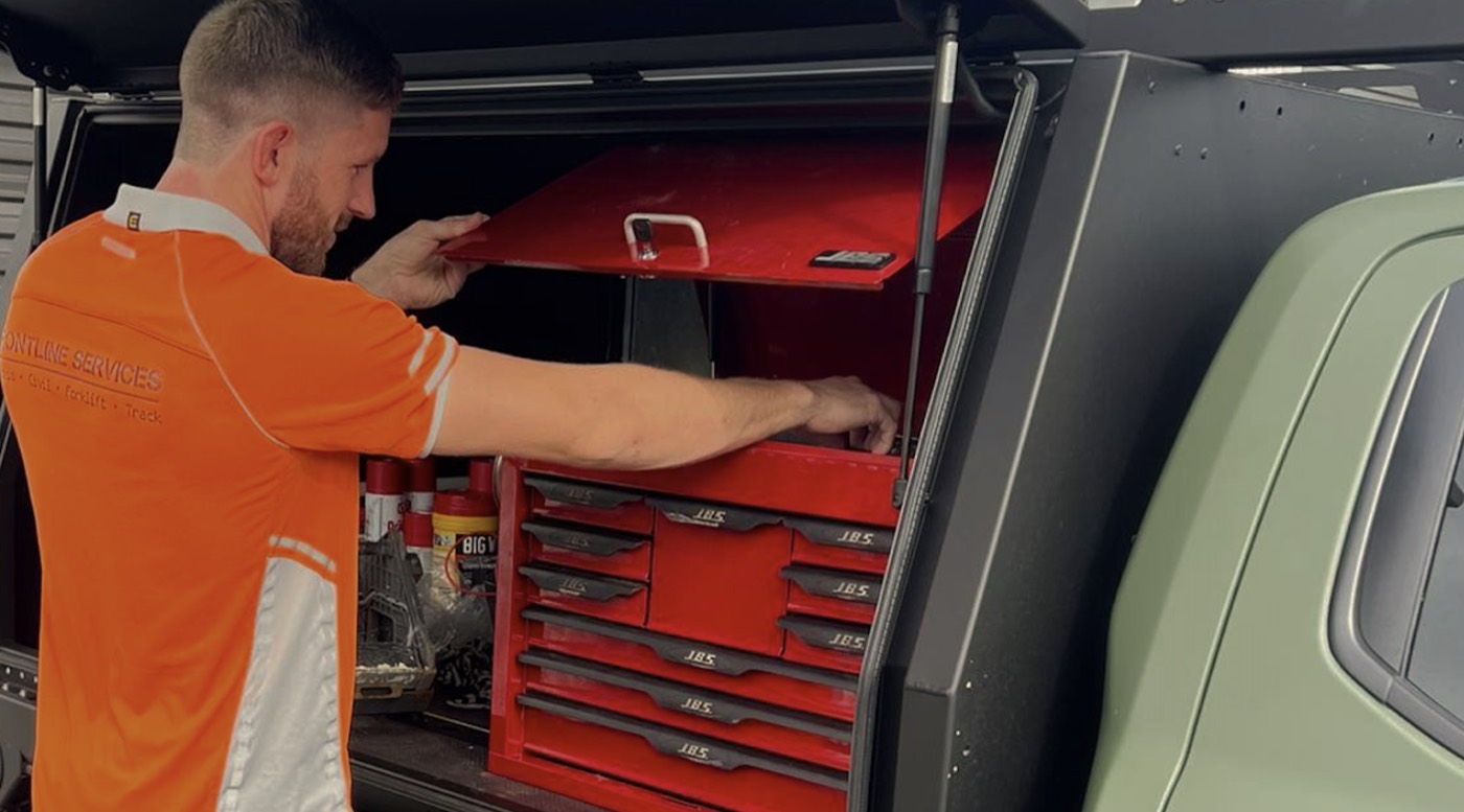Chris Allan selecting tools from the service body of a Frontline Services ute
